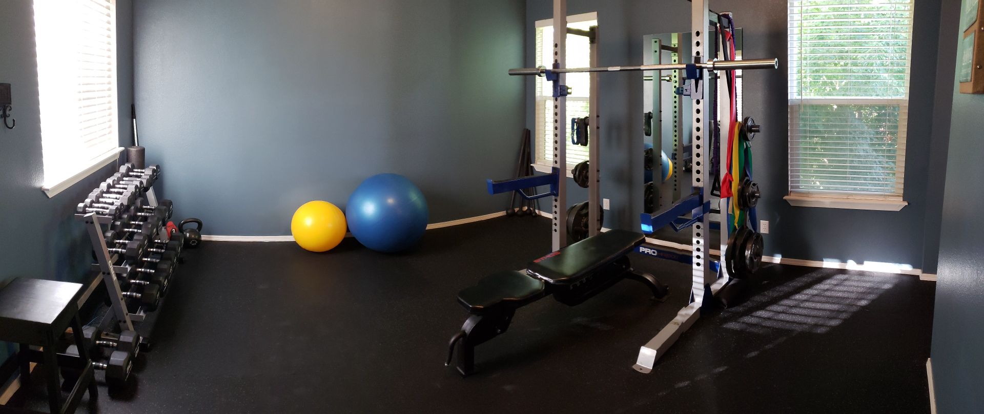 Picture of unique physique gym floor showing full dumbell rack 5-50lbs and half squat rack with pull up bar, other equip