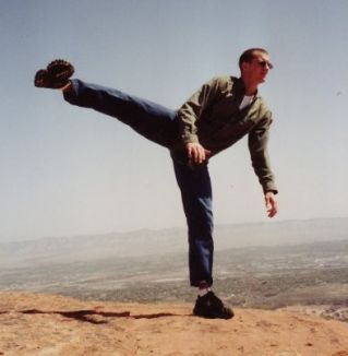 Me standing on a rock at the top of Grand Junction National Monument doing a side kick in the air.